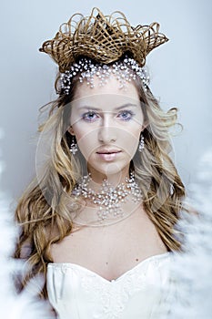Beauty young snow queen with hair crown on her head, complicate hairstyle, winter concept