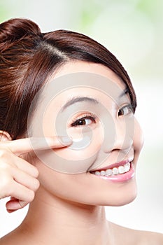Beauty young woman applying cosmetic cream