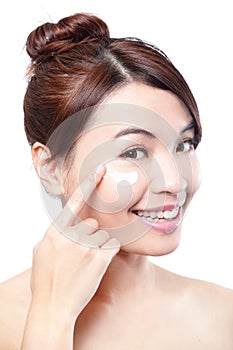 Beauty young woman applying cosmetic cream