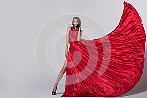 Beauty young woman in fluttering red dress