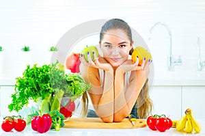 Beauty young woman holding fresh vegetables and fruits in her kitchen at home