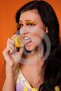 Beauty young woman lick lemon