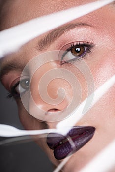 Beauty young woman. Portrait through cellophane