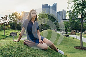 Beauty young woman sitting on the grass Portrait of girl outdoors