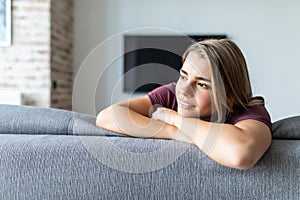 Beauty young woman sitting on sofe at home