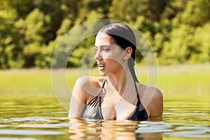 Beauty young woman standing in lake