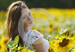 Beauty young woman in sunflower field