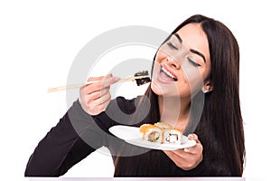 Beauty young woman with sushi in front of her eye on white background