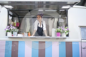 Beauty and young woman works in a food truck