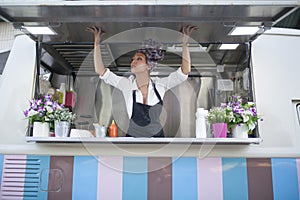 Beauty and young woman works in a food truck