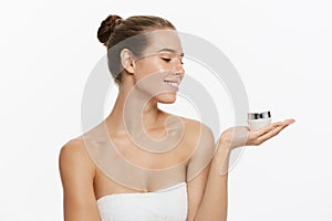 Beauty Youth Skin Care Concept - Beautiful Caucasian Woman Face Portrait holding and presenting cream tube product