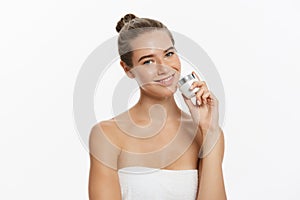 Beauty Youth Skin Care Concept - Beautiful Caucasian Woman Face Portrait holding and presenting cream tube product
