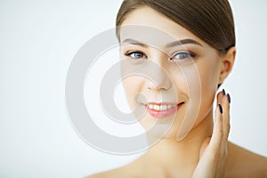 Beauty Youth Skin Care Concept - Close up Beautiful Caucasian Woman Face Portrait applying some cream to her face for skin care.
