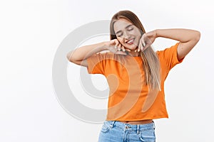 Beauty, youth and women concept. Portrait of dreamy, carefree blond girl close eyes, smiling as daydreaming, stretching