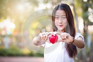 Beautyful asian young girl holding red heart photo