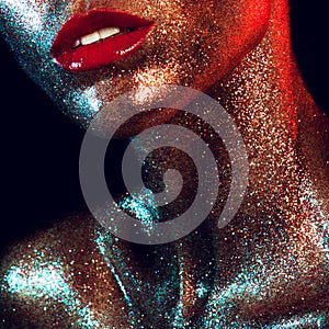 Beautyful girl with gold glitter on her face