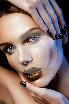 Beautyful girl with gold glitter on her face