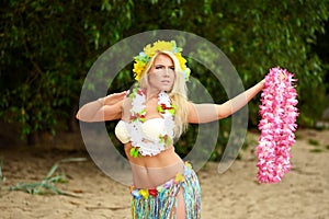 Beautyful hula hawaii dancer girl dancing on beach