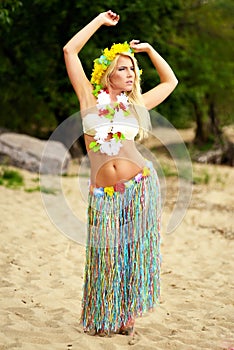 Beautyful hula hawaii dancer girl dancing on beach