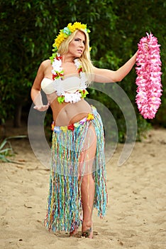 Beautyful hula hawaii dancer girl dancing on beach