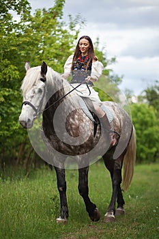 Beautyful woman with horse in Ukrainian national dress.