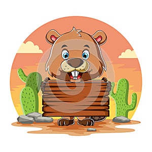 The beaver holding the blank wooden board and standing near the cactus