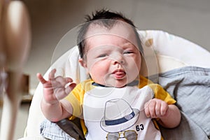 Bebe with yellow and white body lying on baby hammock