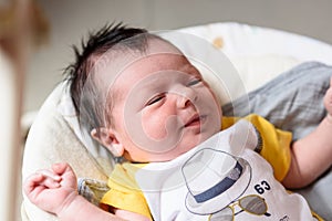 Bebe with yellow and white body lying on baby hammock