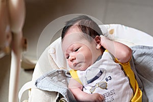 Bebe with yellow and white body lying on baby hammock