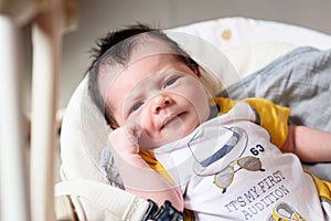 Bebe with yellow and white body lying on baby hammock