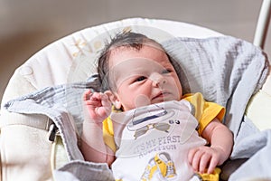 Bebe with yellow and white body lying on baby hammock