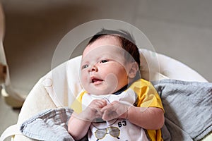 Bebe with yellow and white body lying on baby hammock