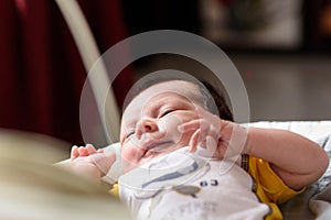 Bebe with yellow and white body lying on baby hammock