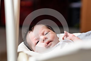 Bebe with yellow and white body lying on baby hammock