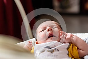 Bebe with yellow and white body lying on baby hammock