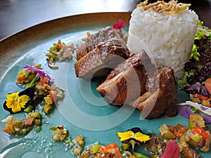 Bebek areh sambal matah is Indonesian traditional food, savory duck meat combined with fresh matal sauce photo