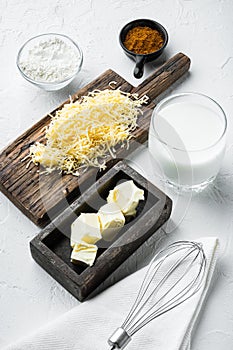 Bechamel sauce ingredients , on white stone  background