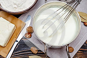 Bechamel sauce in a pan and ingredients