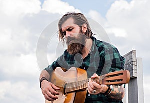 Become popular. music performer musician. musical string instrument. mature charismatic male guitarist. guy with beard