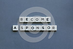 ' Become A Sponsor ' word made of square letter word on grey background photo