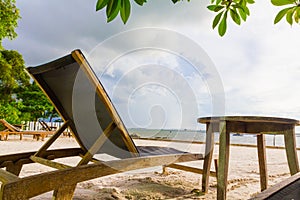 Bed beach and wood table under tree and on the beach