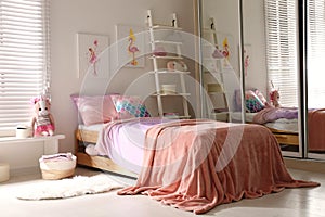 Bed with beautiful linens in children`s room