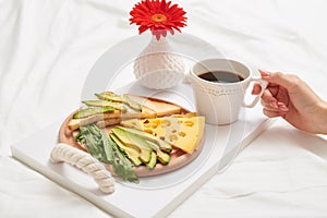 Bed breakfast with coffee, juicy avocado and cheddar