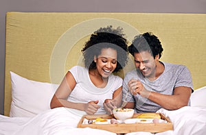 Bed, breakfast and couple with smile for fruit, nutrition and healthy with food for eating in morning. Bedroom, man and