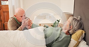 Bed, care and senior couple holding hands for support, bonding and compassion at home together. Retirement home