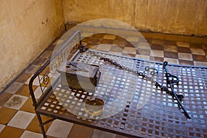 Bed in a cell in Tuol Sleng (S21) Prison