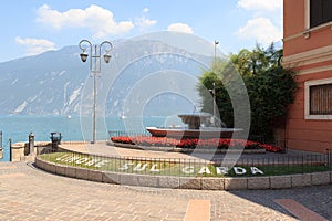 Bed of flowers with Limone sul Garda lettering, Lake Garda and mountains
