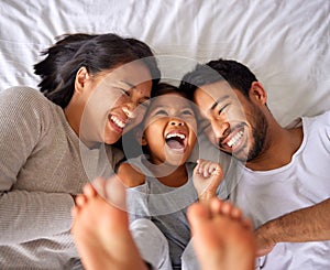 Bed, fun and happy family playing, wake up and happy from above, tickle and laughing in their home. Bedroom, games and