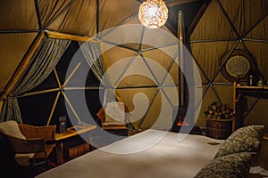 Bed and the interior of dome in luxury glamping hotel close to National Park Torres del Paine, Chile photo