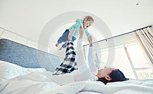 Bed, morning and a mother playing with her daughter in a bedroom of their home together for bonding. Family, kids or